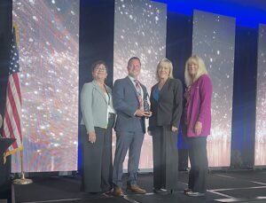 employees accepting a safety award on stage