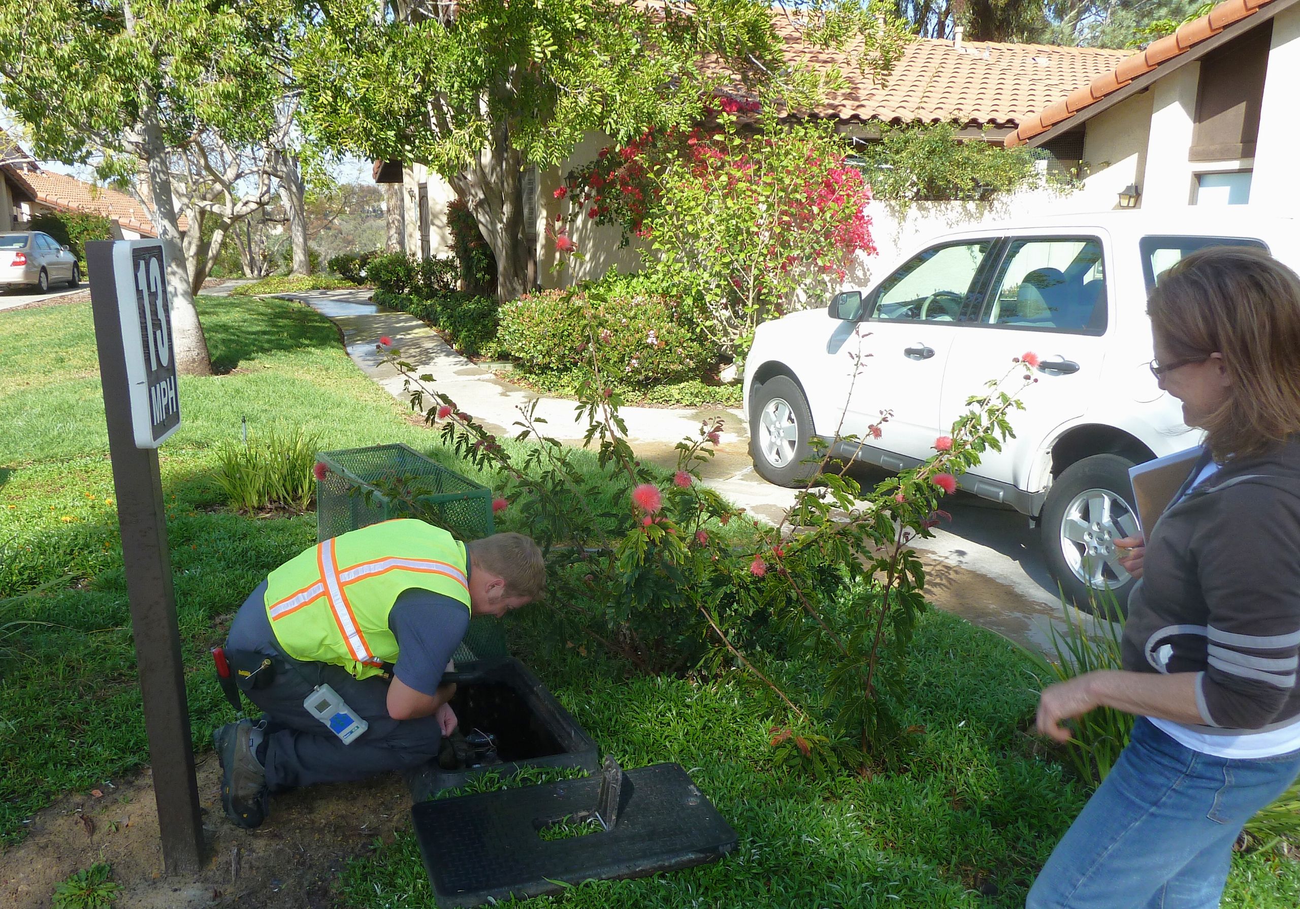 technician inspects water meter