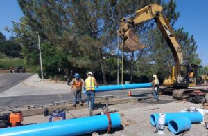 construction crew in street, installing pipe