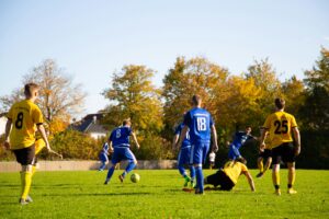 kids playing soccer on turf