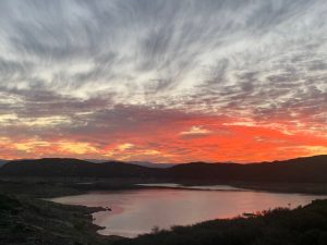 morning red sky over reservoir