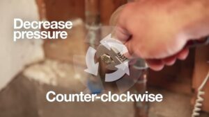 adjusting a pressure regulator using a wrench; decrease pressure by turinng counter-clockwise